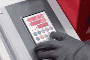 Close up of a hand operating the Elgo Controller