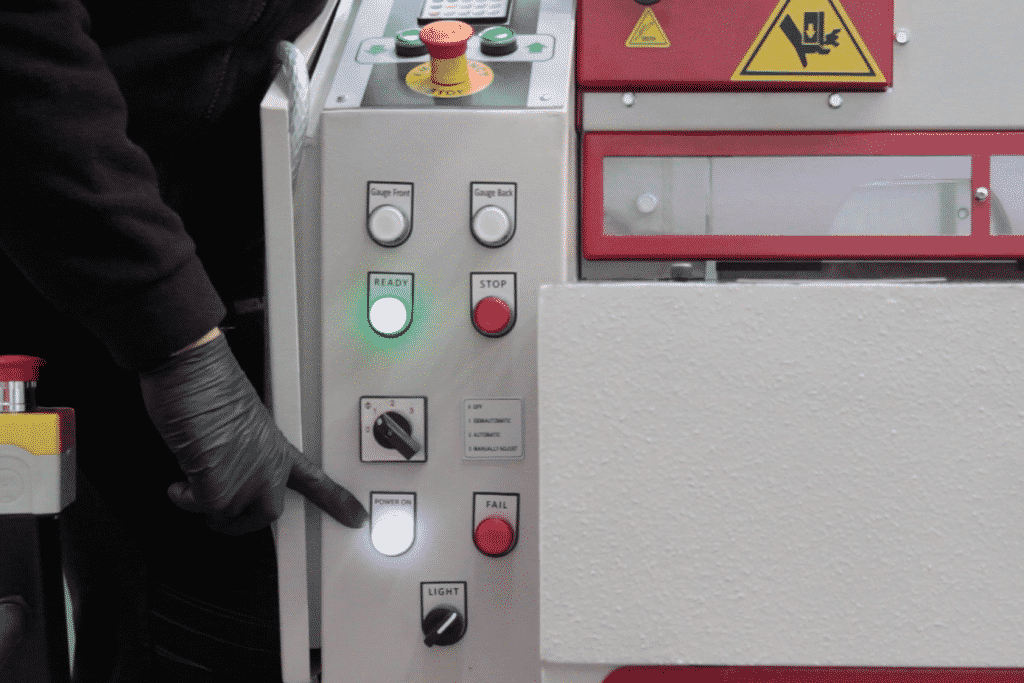 Image of the front of the machine with hand pointing at the controls