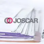 Image of the Joscar logo with paperwork in the background