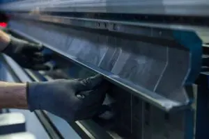 Image of hands adjusting top tooling on a pressbrake