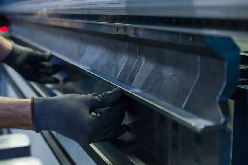 Image of hands adjusting top tooling on a pressbrake