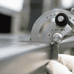 Image of gauge checking whether a sheet of metal has bowed