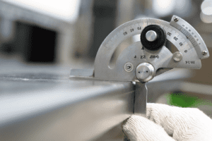 Image of gauge checking whether a sheet of metal has bowed