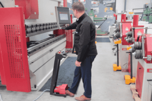 Image of an operator bringing down the top beam on a Morgan Rushworth Press Brake