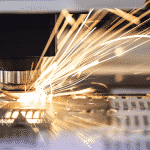 Close up of laser head cutting metal