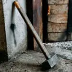 old sledgehammer standing in garage