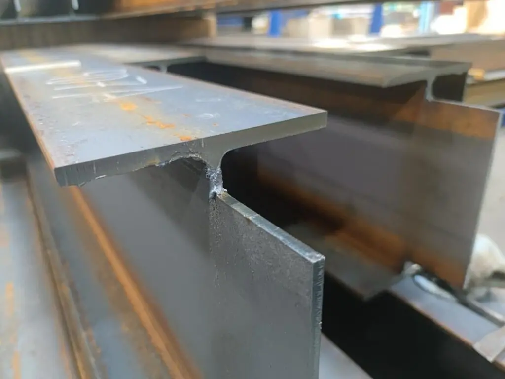 A freshly cut steel beam, with a segment cut out of it.