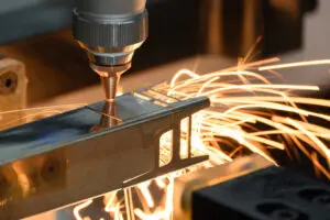Close up scene the fiber laser cutting machine cut the square shape stainless steel tube with sparkling light. Close up of a Tube Laser Cutting