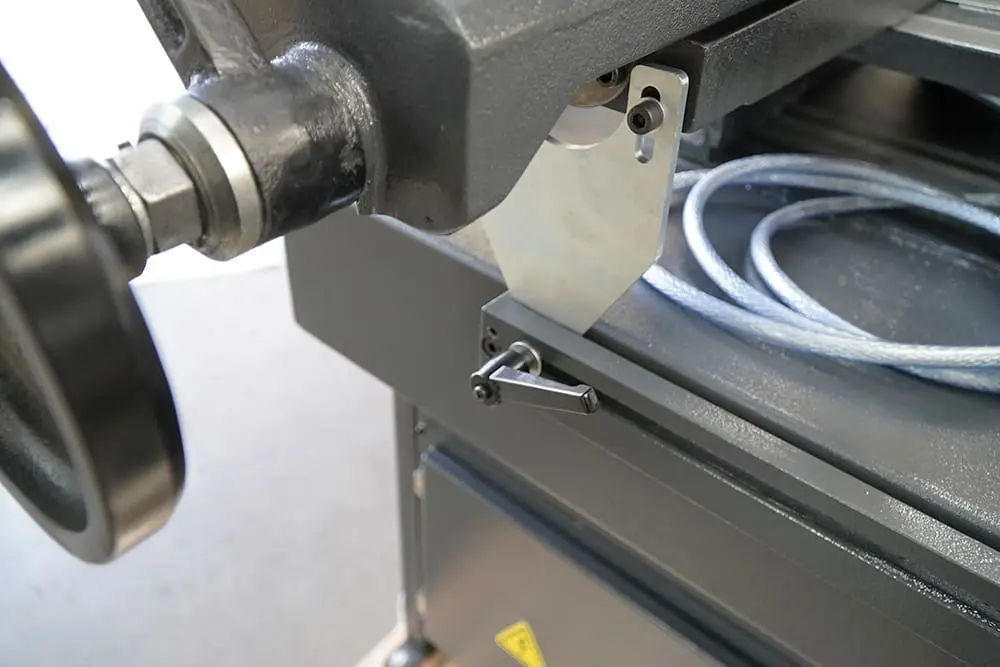 Adjustable material stop assembly