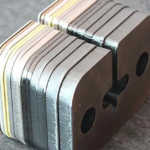 Laser-cut steel sample parts for comparing CNC production costs