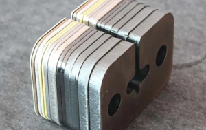 Laser-cut steel sample parts for comparing CNC production costs