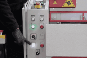 Image of the front of the machine with hand pointing at the controls