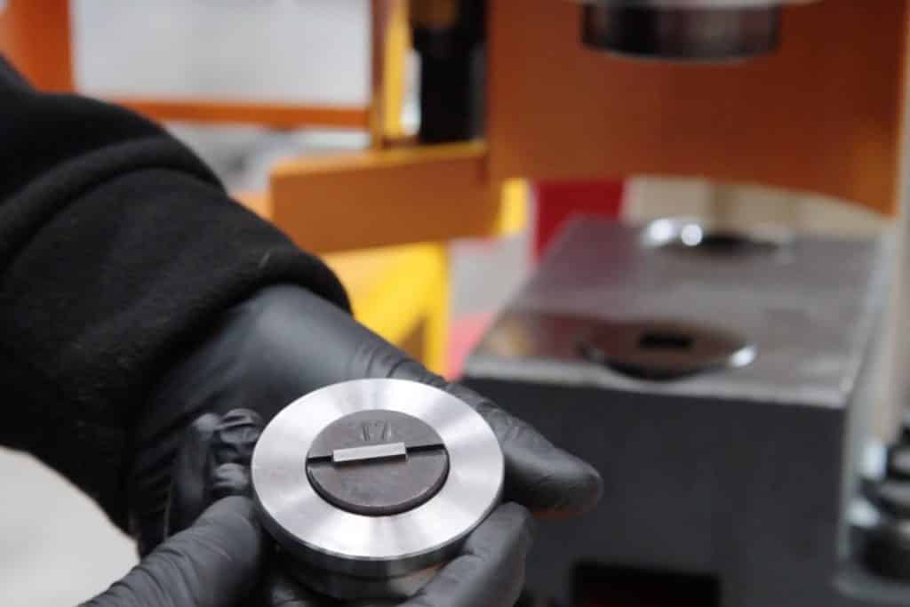 Image of someone safely removing a punch on a steelworker