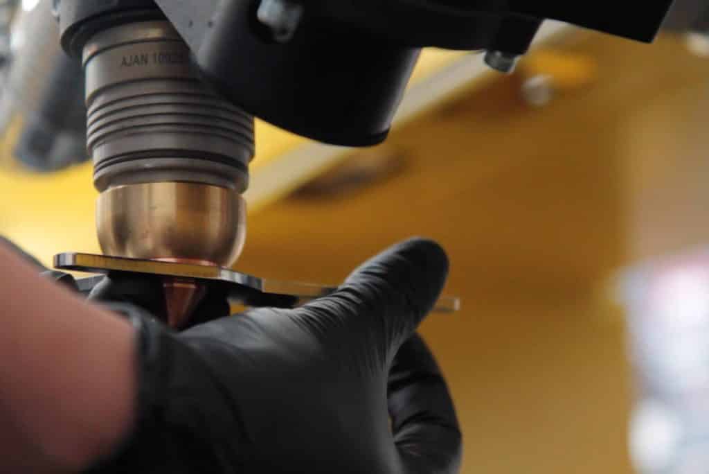 Close up image of a hand removing the Shield Cap on the Ajan Plasma Torch